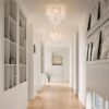 Rustic ceiling light chandelier with metal frame and soft glowing bulbs.