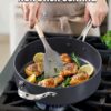 Black nonstick sauté pan with glass lid – induction compatible.