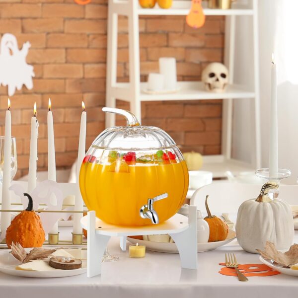Durable pumpkin-shaped glass drink dispenser with lid and raised stand for easy serving.