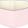 Glossy pink enamel Dutch oven with superior heat retention.