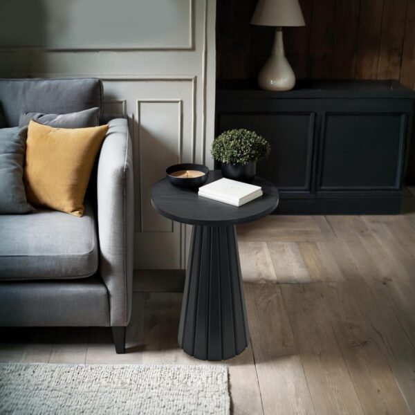 Elegant round pedestal side table with tapered base, adding sophistication to modern interiors.