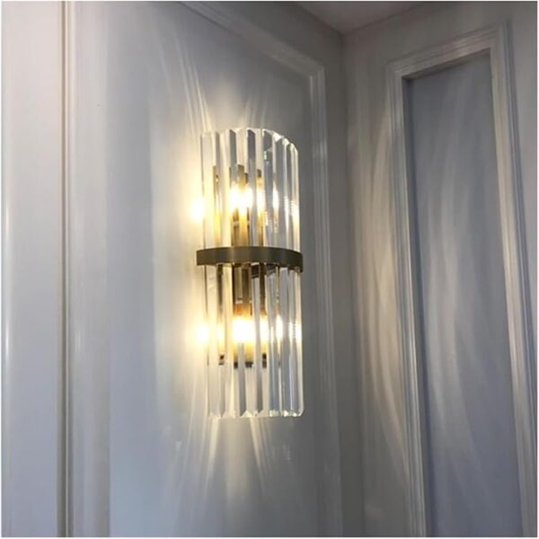 Modern crystal wall sconce with sparkling crystal drops and golden finish for elegant home decor.